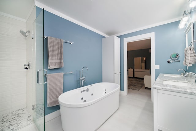 bathroom with ornamental molding, a freestanding tub, a sink, and a shower stall