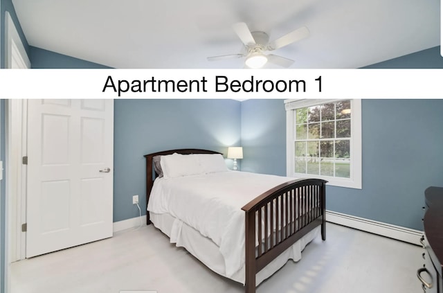 bedroom with a baseboard heating unit, ceiling fan, and baseboards