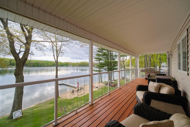 wooden terrace featuring a water view