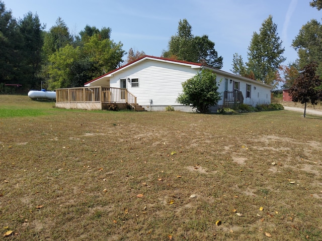 view of property exterior with a lawn and a wooden deck