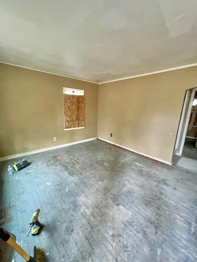 unfurnished room with crown molding and baseboards