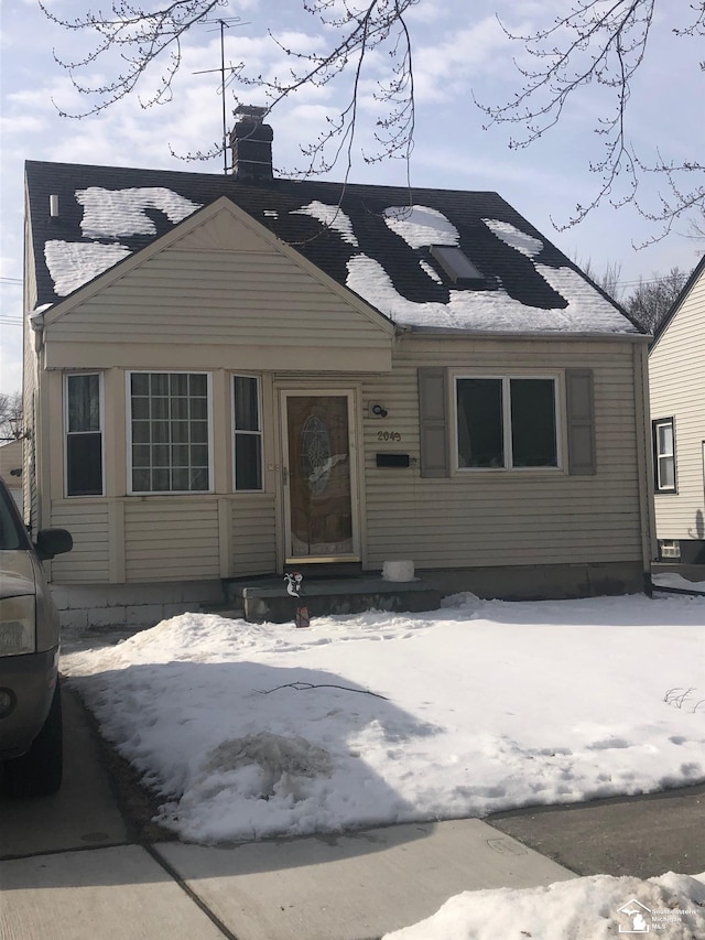 view of front of home featuring a chimney