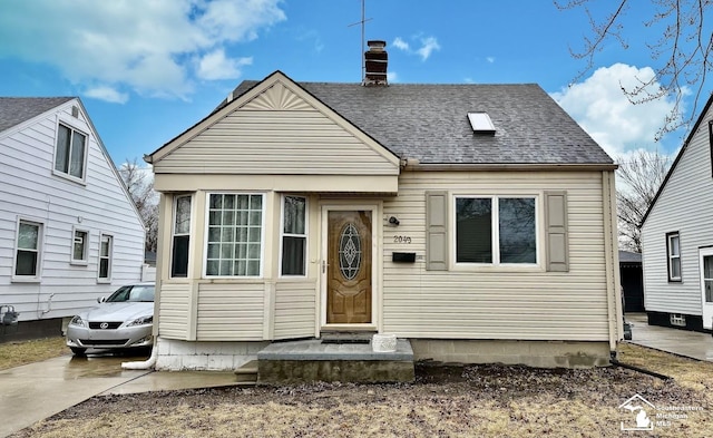 view of front of home featuring a chimney and roof with shingles