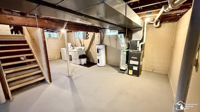 below grade area featuring water heater, separate washer and dryer, stairway, and heating unit