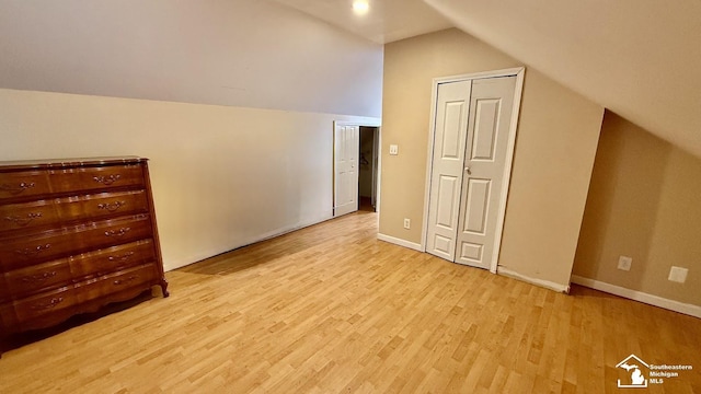 additional living space featuring lofted ceiling, wood finished floors, and baseboards