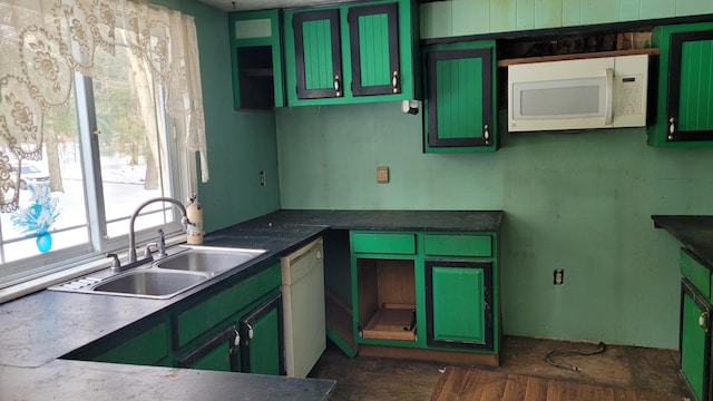 kitchen with white appliances, a sink, and green cabinets