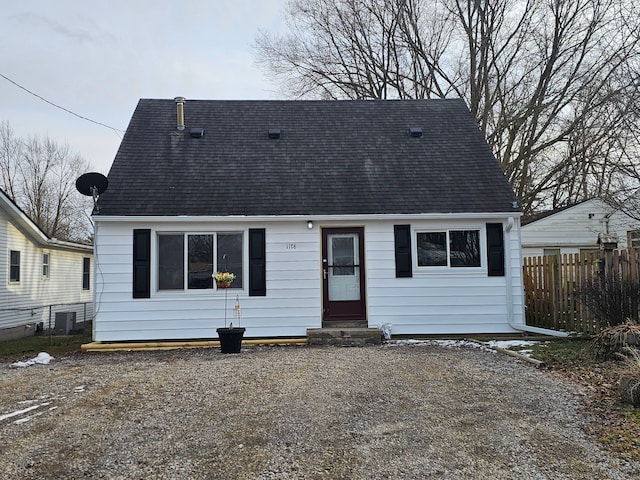 view of front facade with fence, driveway, and entry steps