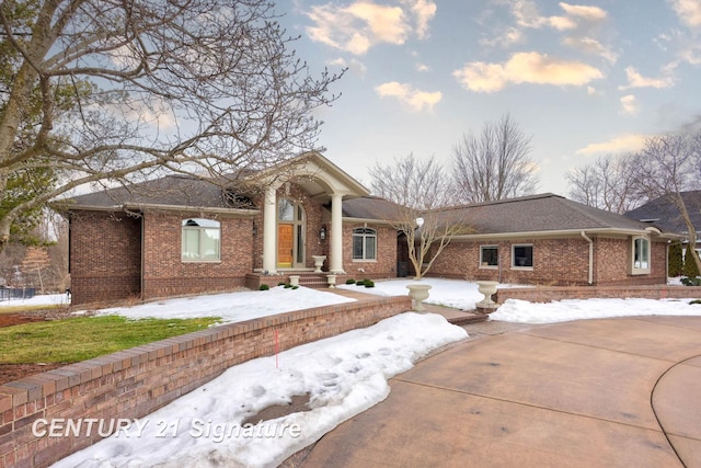 neoclassical / greek revival house with brick siding and driveway