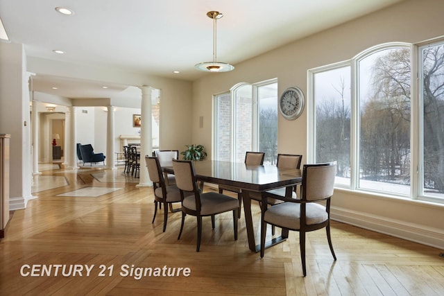 dining space featuring recessed lighting, baseboards, and ornate columns