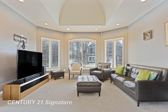 carpeted living room with lofted ceiling, baseboards, and recessed lighting