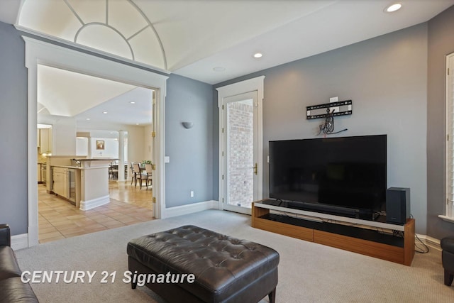 living room with recessed lighting, light carpet, baseboards, and light tile patterned floors