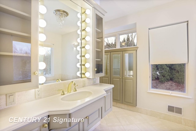 bathroom featuring visible vents, vanity, and tile patterned floors