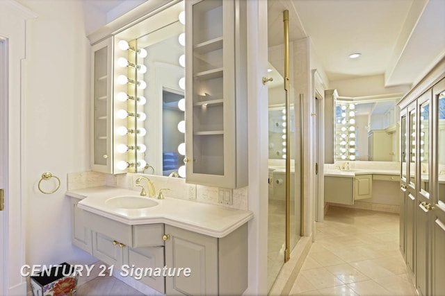 full bathroom featuring a shower stall, vanity, and tile patterned floors