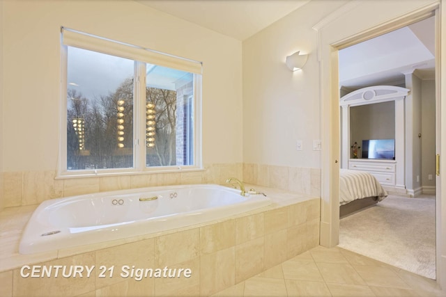 ensuite bathroom with tile patterned floors, a garden tub, connected bathroom, and a healthy amount of sunlight