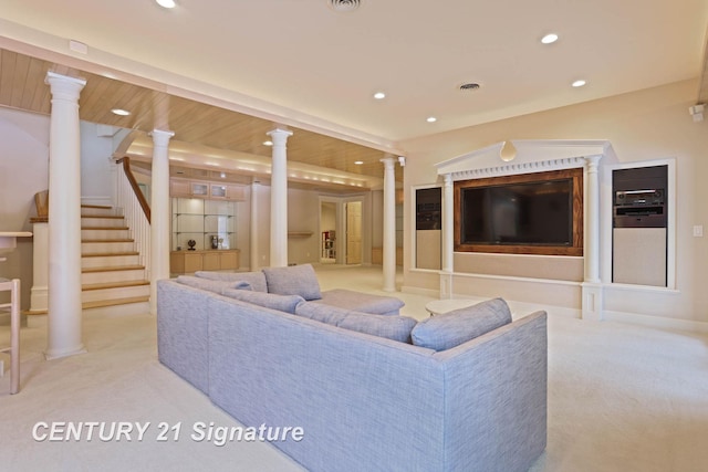 carpeted living room with ornate columns, visible vents, stairway, and recessed lighting