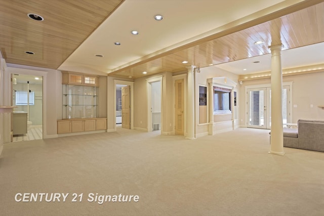 empty room featuring wooden ceiling, recessed lighting, light colored carpet, and ornate columns