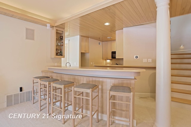 kitchen featuring decorative columns, recessed lighting, visible vents, wood ceiling, and black microwave