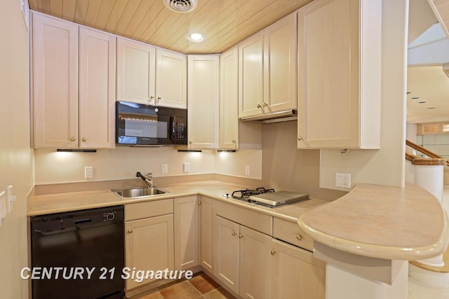 kitchen featuring visible vents, wood ceiling, light countertops, black appliances, and a sink