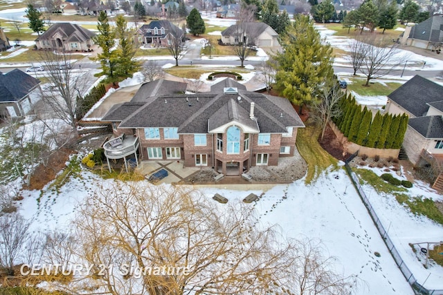 snowy aerial view with a residential view