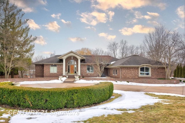 view of front facade featuring concrete driveway and brick siding