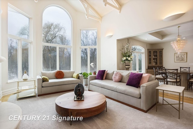 sunroom featuring a chandelier and vaulted ceiling with beams