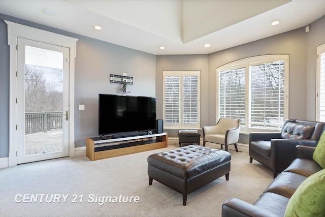 carpeted living area with baseboards and recessed lighting