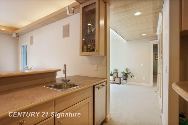 kitchen with glass insert cabinets, light colored carpet, a sink, and dishwashing machine