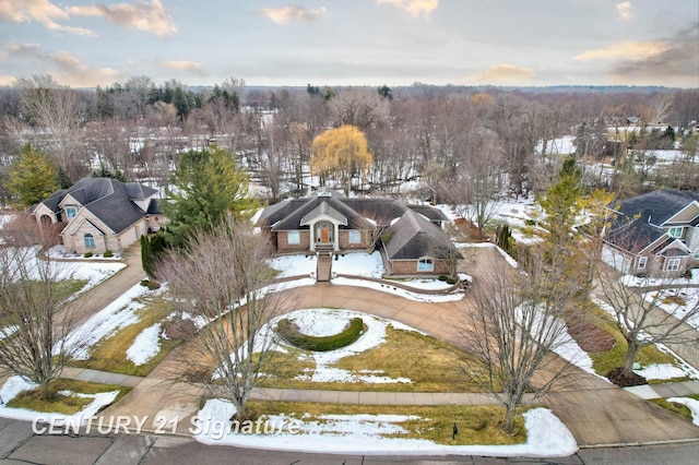 snowy aerial view with a residential view