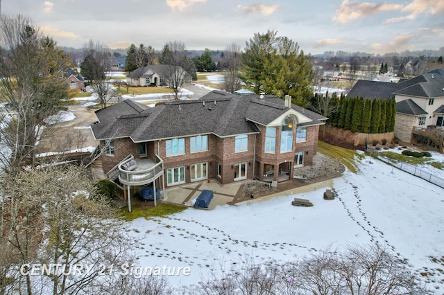 snowy aerial view featuring a residential view