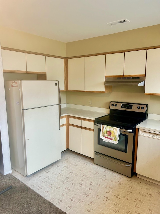 kitchen featuring white appliances, visible vents, light floors, light countertops, and under cabinet range hood