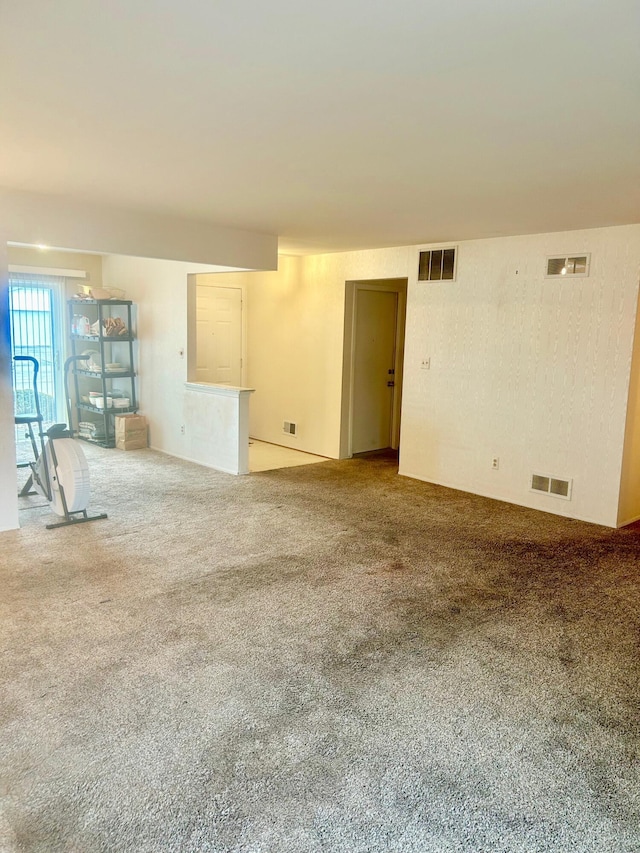 spare room featuring carpet flooring and visible vents