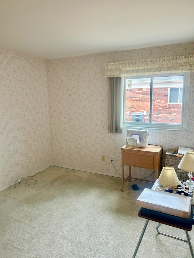 interior space featuring carpet and wallpapered walls