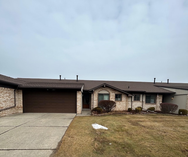 ranch-style house featuring a garage, brick siding, driveway, and a front lawn