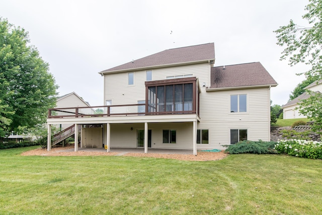 back of house featuring a wooden deck, a sunroom, stairs, a yard, and a patio area