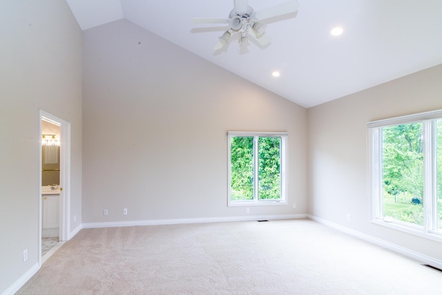 empty room with light carpet, visible vents, a wealth of natural light, and baseboards