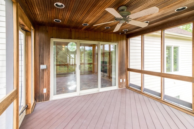 unfurnished sunroom featuring wooden ceiling and ceiling fan