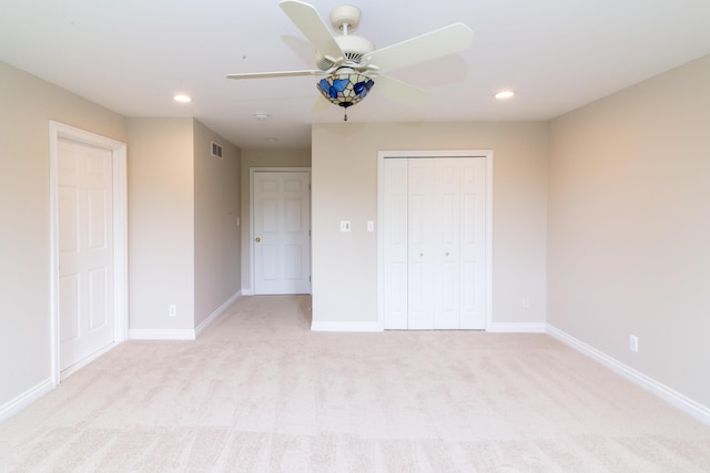 unfurnished bedroom featuring recessed lighting, baseboards, and light colored carpet