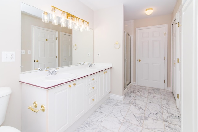 bathroom with toilet, marble finish floor, a sink, and a stall shower