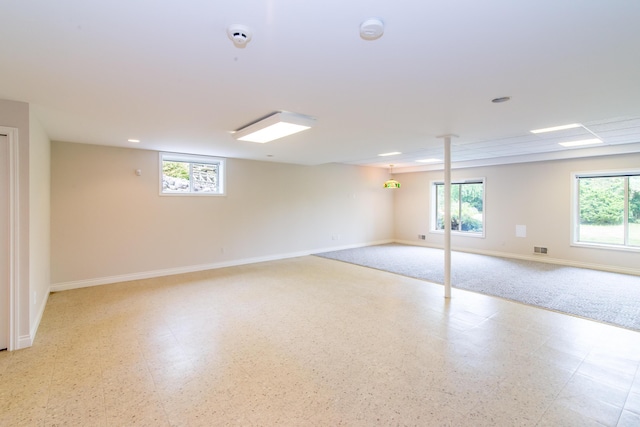 basement with light floors, plenty of natural light, and baseboards