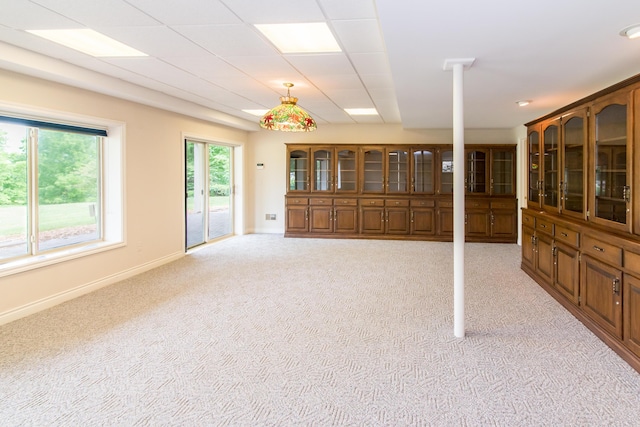 spare room with light carpet and baseboards