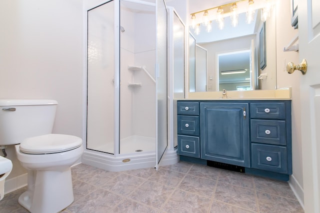 full bath featuring toilet, a stall shower, and vanity