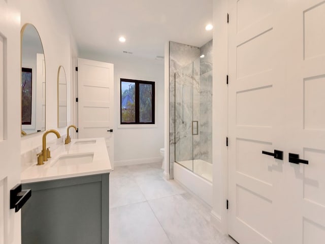 full bath featuring double vanity, recessed lighting, toilet, a sink, and baseboards