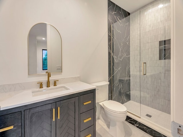 full bathroom featuring marble finish floor, a shower stall, toilet, and vanity