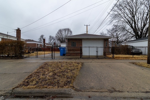 exterior space featuring a gate, fence, and concrete driveway