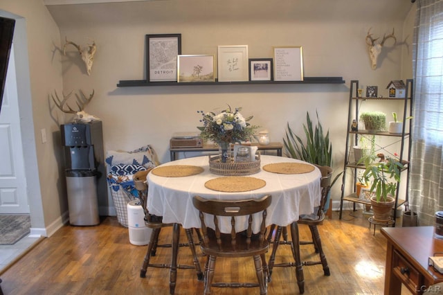 dining room with baseboards and wood finished floors