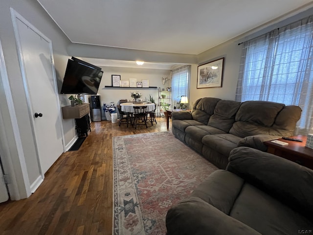 living area with wood finished floors and baseboards