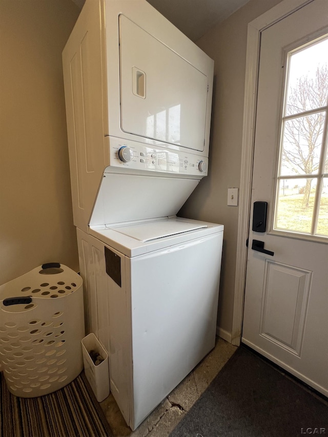 laundry area featuring laundry area and stacked washer / dryer