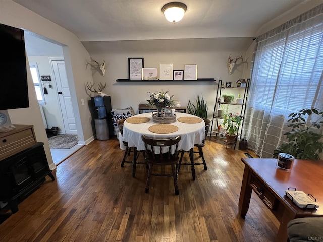 dining area featuring dark wood-style flooring and baseboards