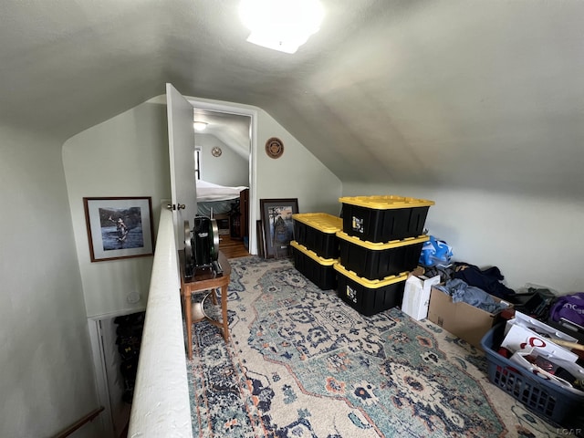 carpeted bedroom with lofted ceiling