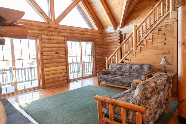 living area featuring wood finished floors, visible vents, wood ceiling, stairs, and beamed ceiling